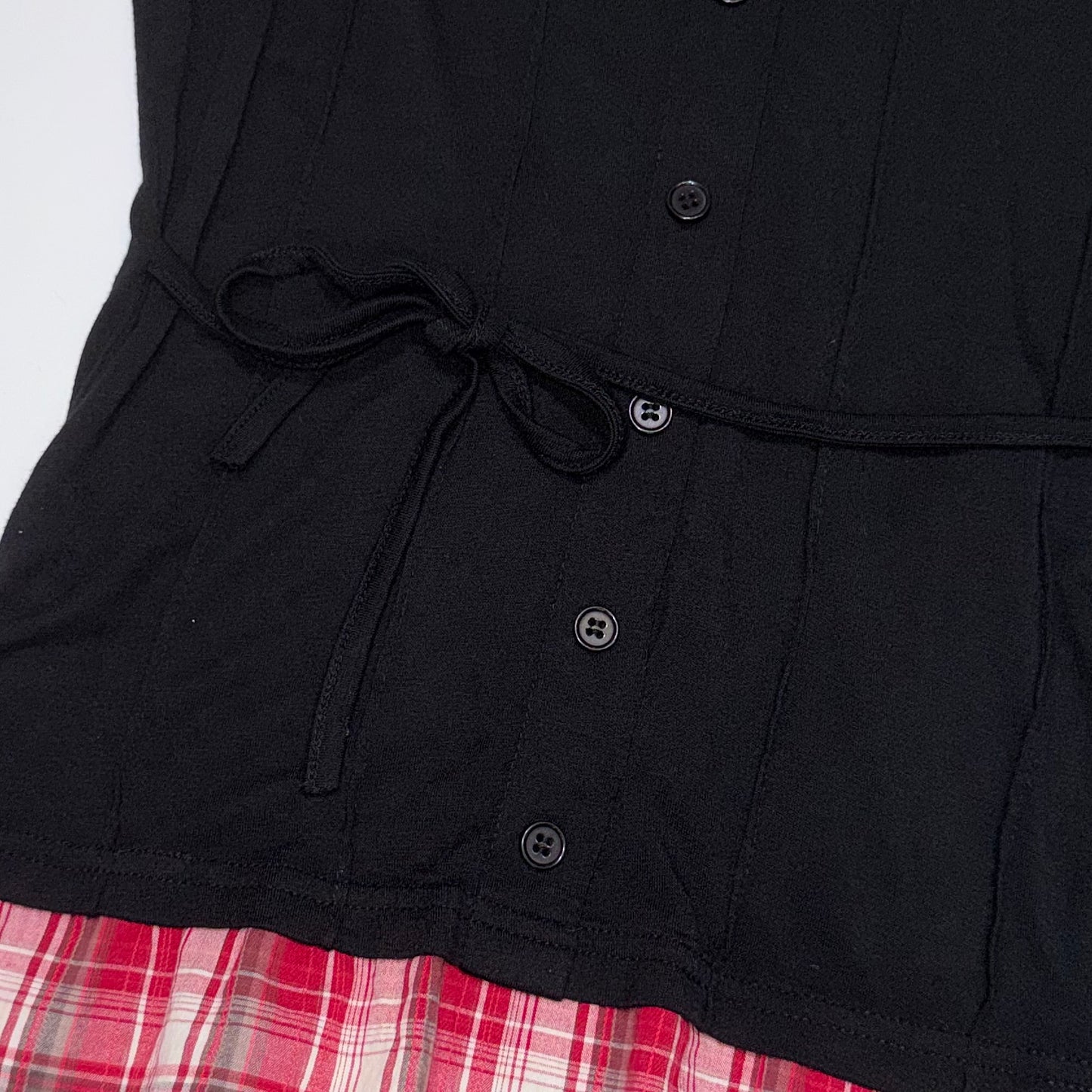 Layered red plaid shirt with black corset style vest