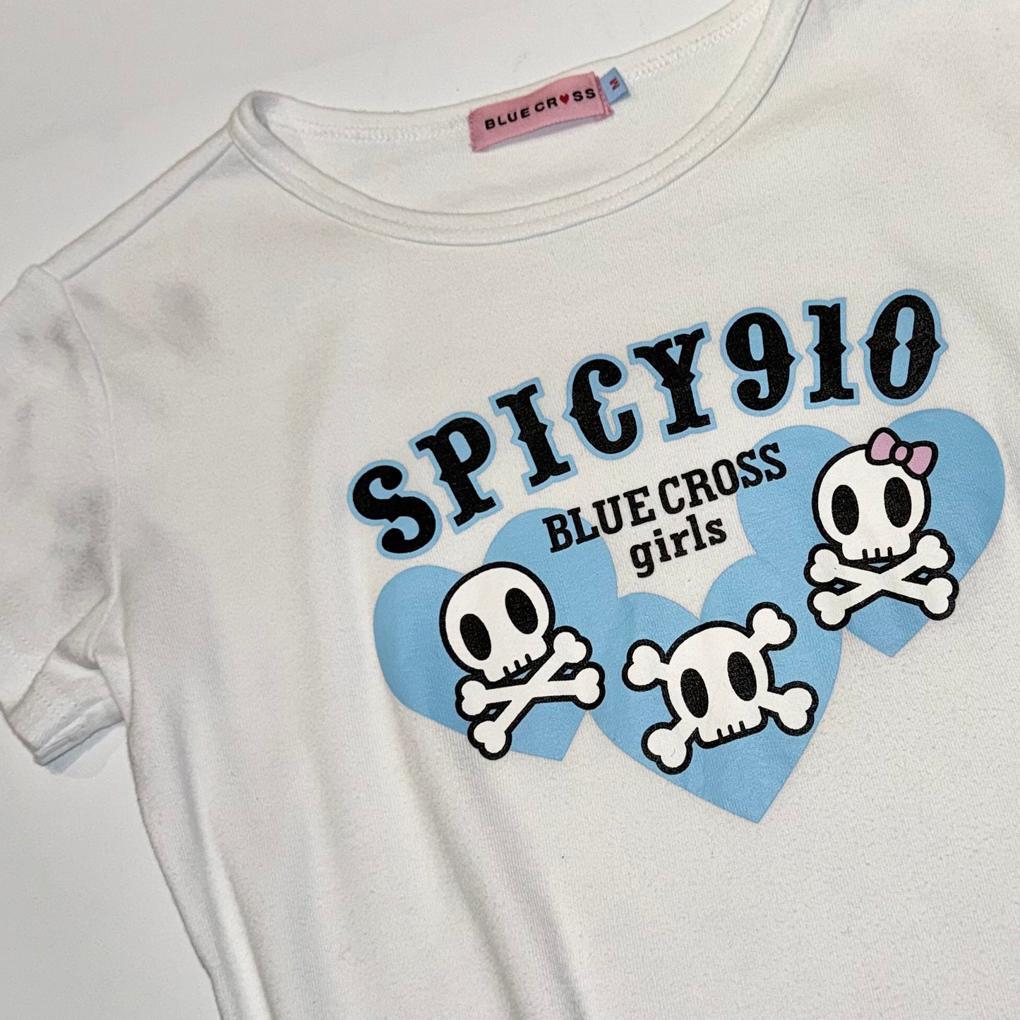 Blue cross skull white top