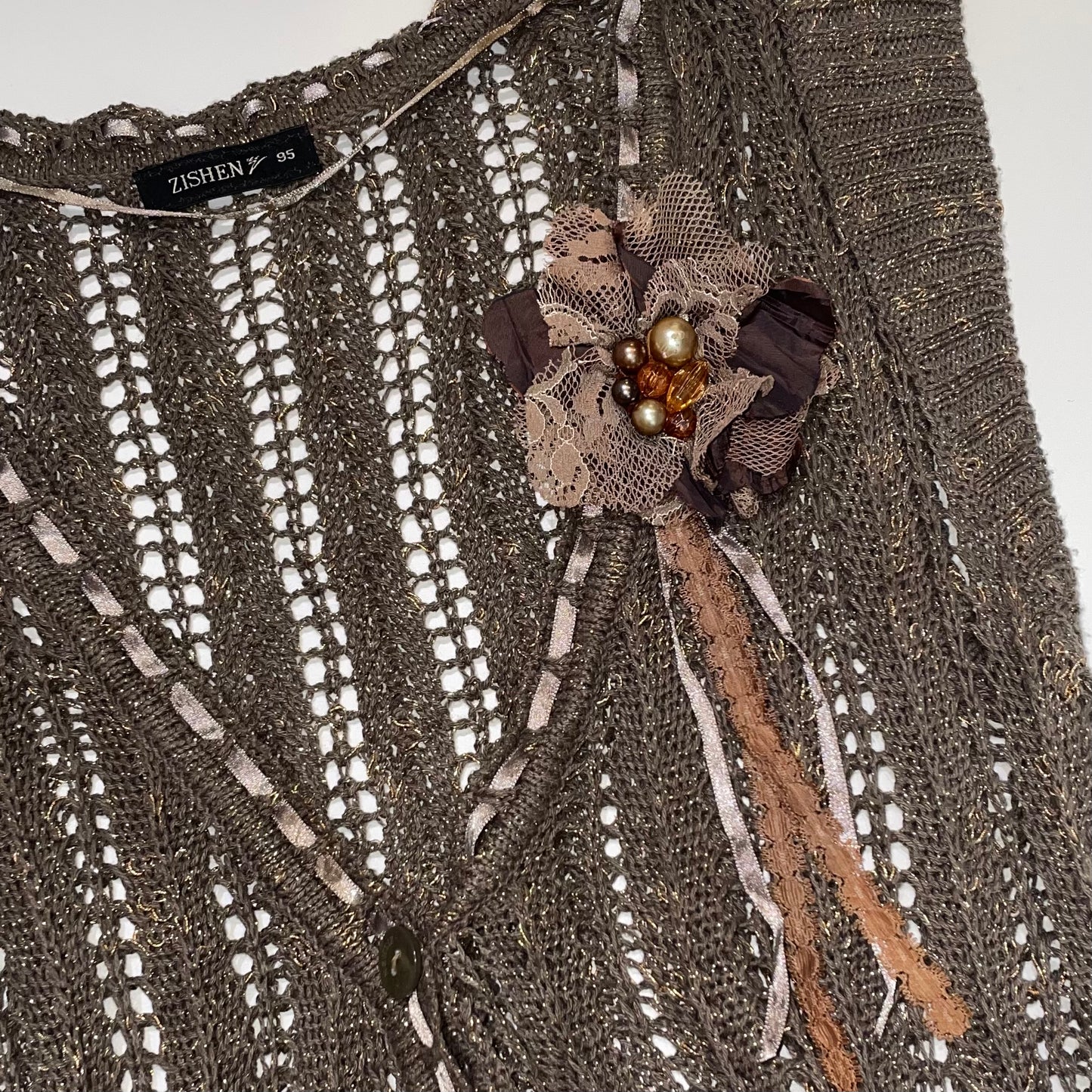 Knit vest with lace flower pin