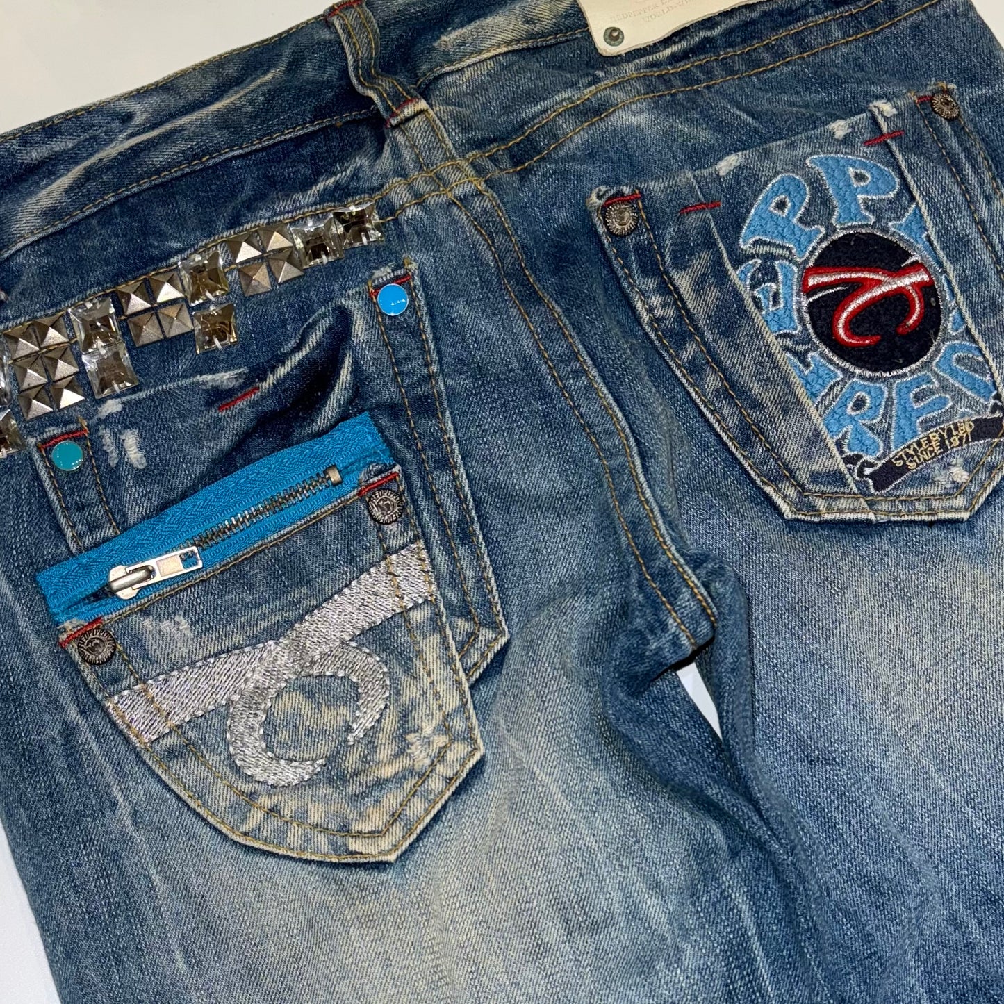Red pepper embroidered low rise bootcut jeans