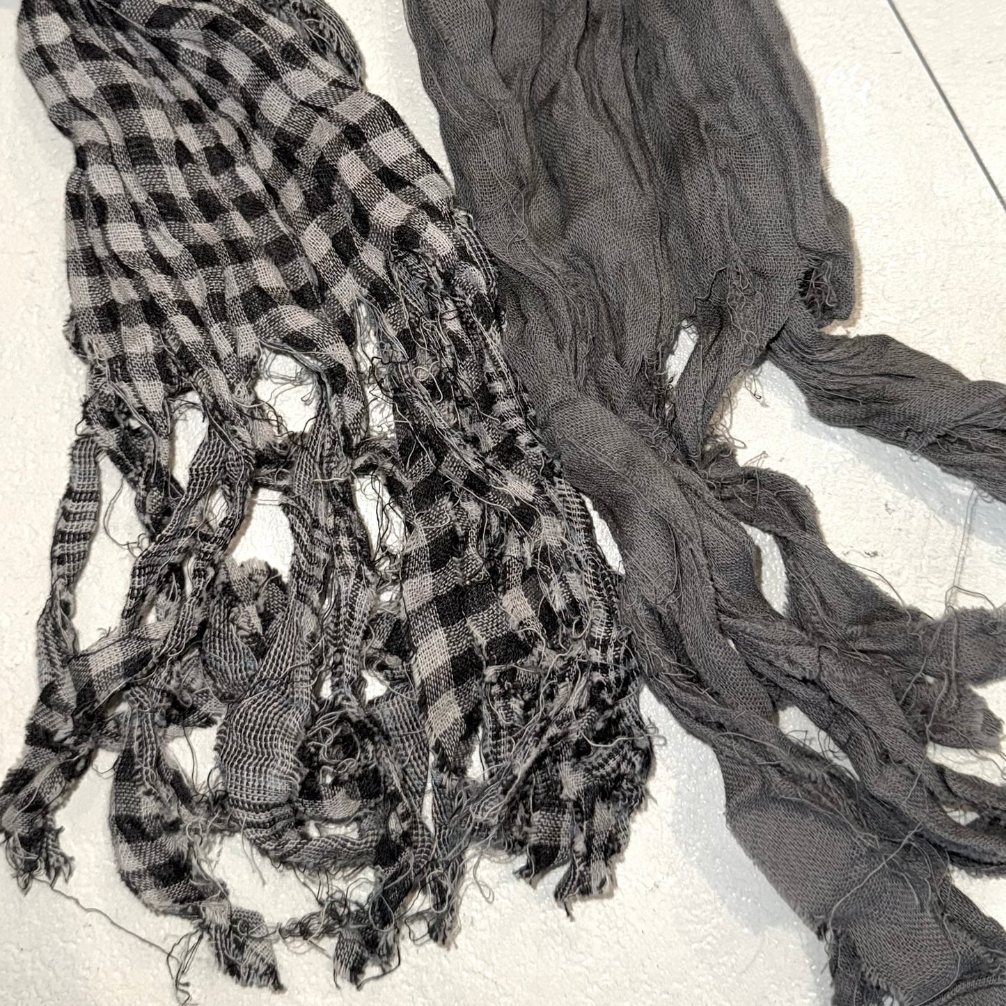 Grey black checkered scarf with frayed edges