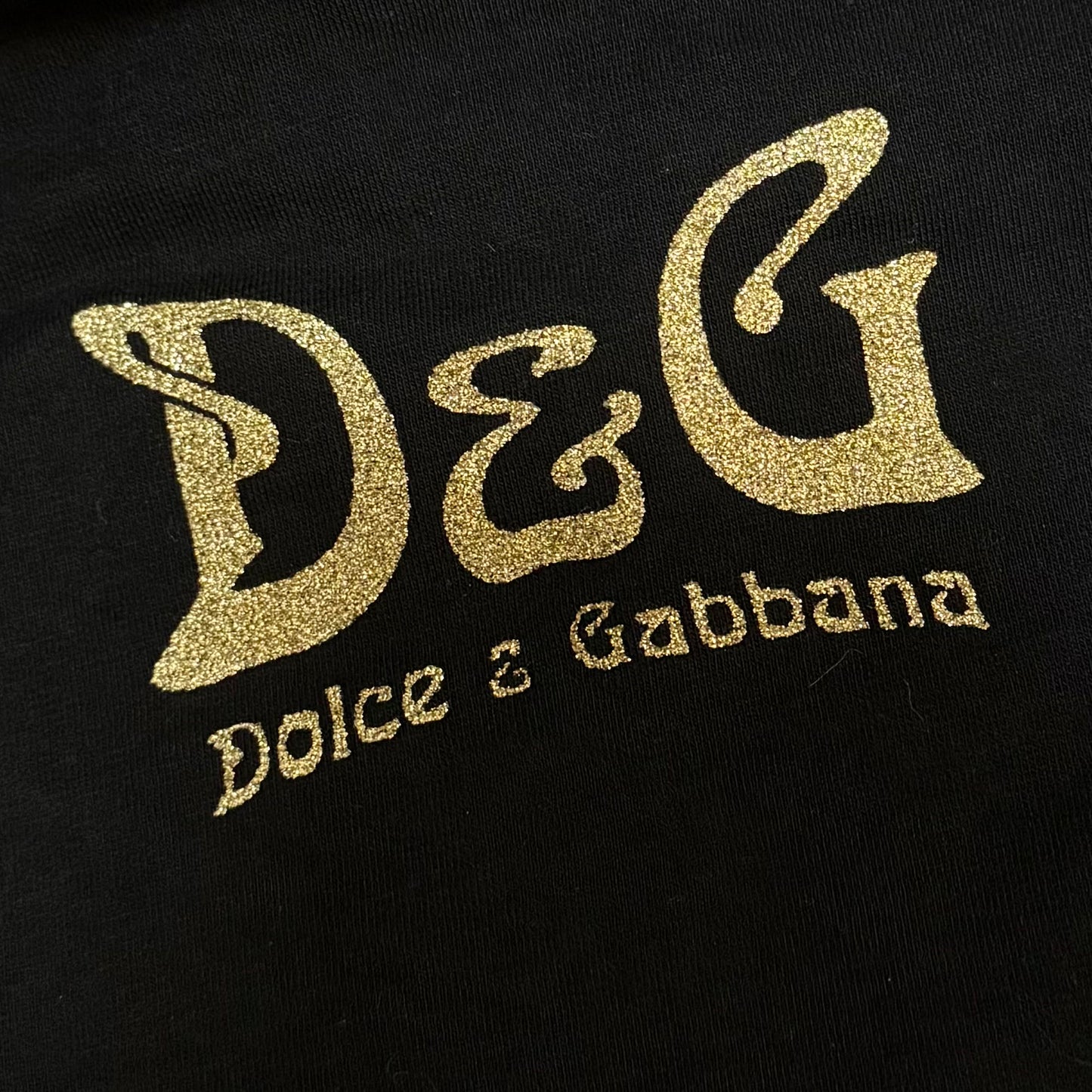 Dolce & Gabbana off-shoulder long sleeve with "I want stardom" signature golden graphic print