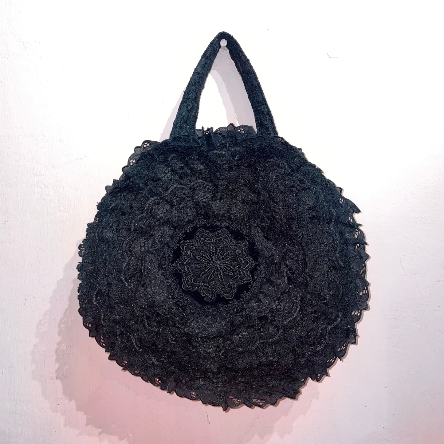 Black lace circle handbag with pin